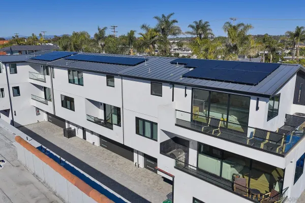 an aerial view of residential houses with outdoor space