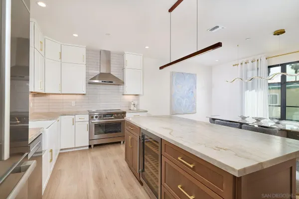 a kitchen with a stove a sink and a refrigerator