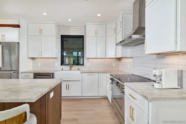 a kitchen with a sink stove and cabinets