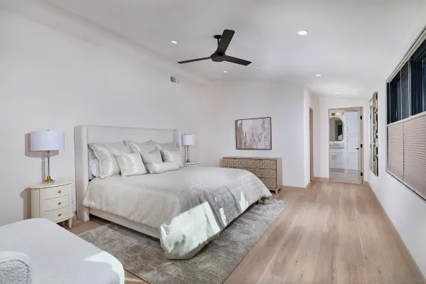 a bedroom with a bed and a night stand