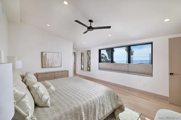 a bedroom with a large bed and a large window