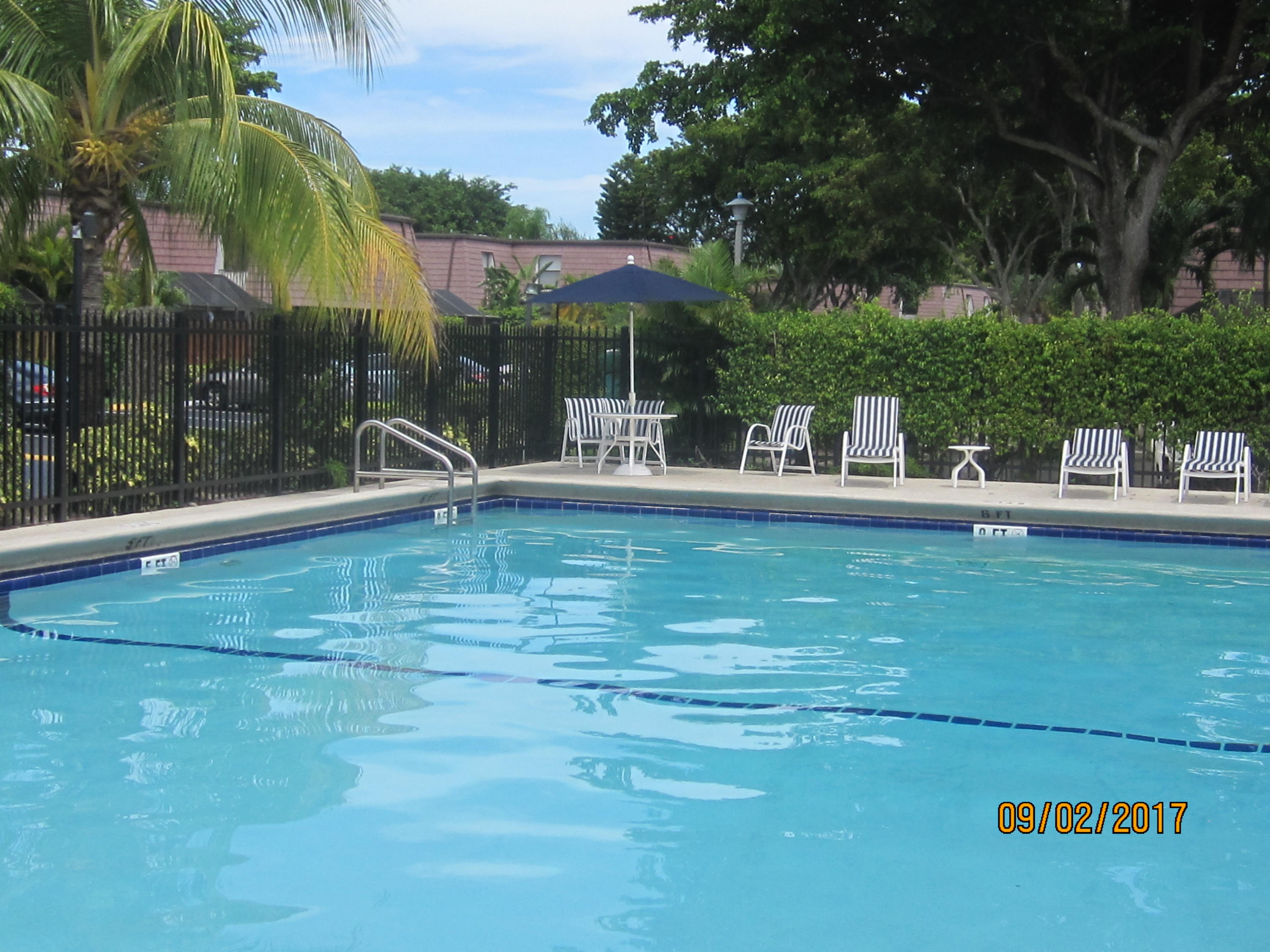 7515 Courtyard Run East Boca Raton, FL 33433 - Photo 14 of 16 a swimming pool with outdoor seating and yard