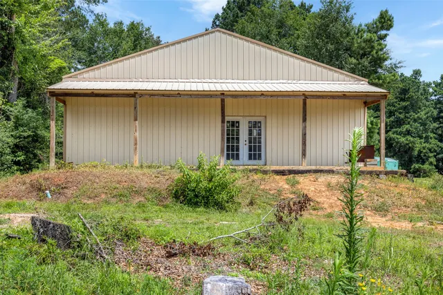 a view of a white house with garden