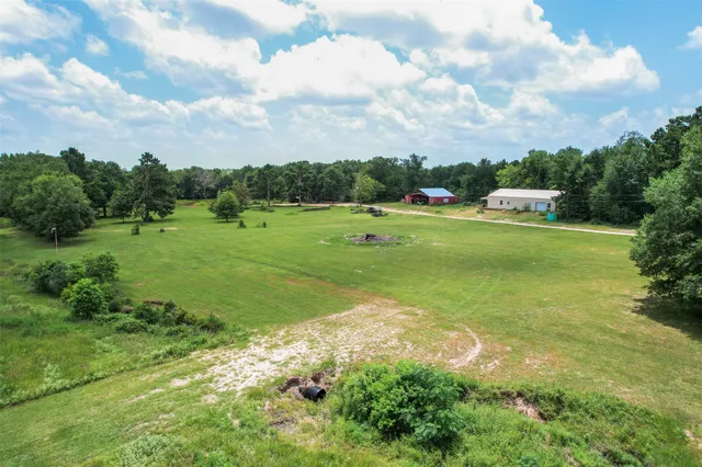 a big yard with lots of green space houses in back
