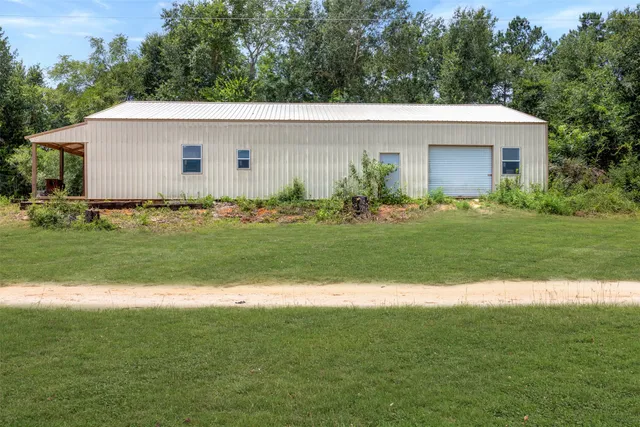 a aerial view of a house and a yard and trees