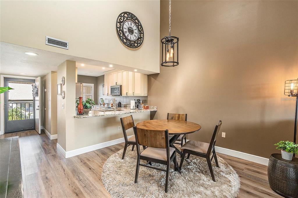 8210 Aquila Street, Unit 223 Port Richey, FL 34668 - Photo 16 of 36 a view of a dining room with furniture and a kitchen