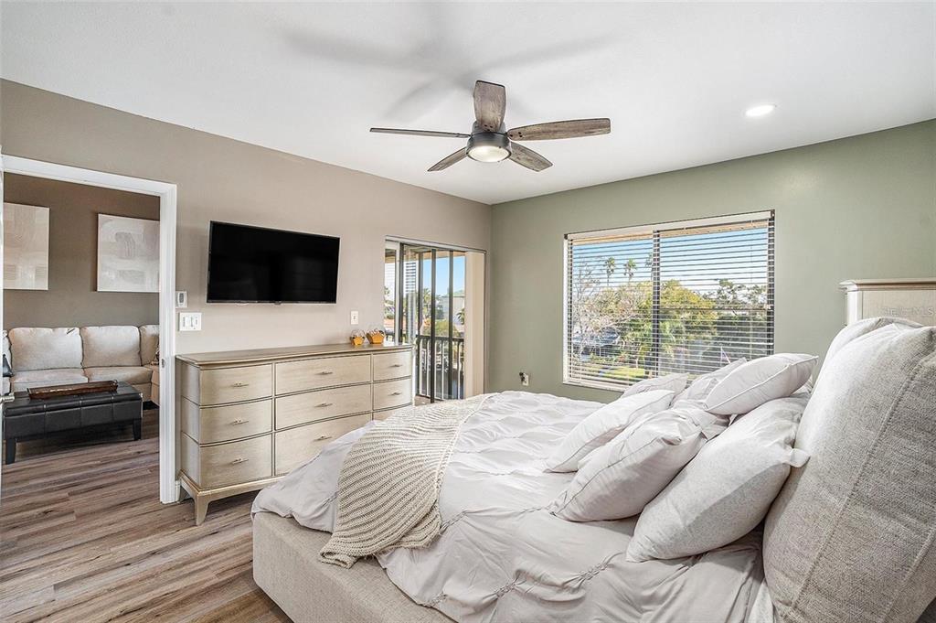 8210 Aquila Street, Unit 223 Port Richey, FL 34668 - Photo 20 of 36 a bedroom with a bed and a flat screen tv