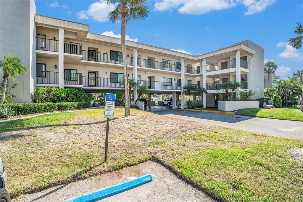 8210 Aquila Street, Unit 223 Port Richey, FL 34668 - Photo 2 of 36 a view of building with yard