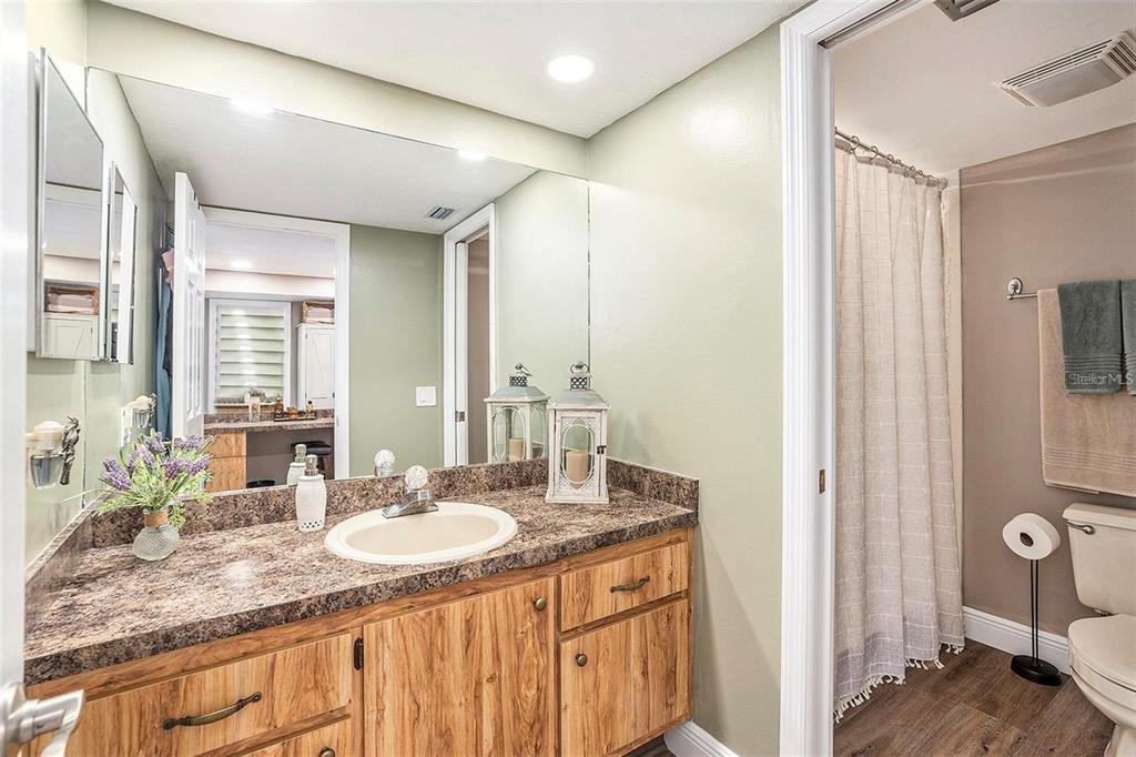 8210 Aquila Street, Unit 223 Port Richey, FL 34668 - Photo 22 of 36 a bathroom with a granite countertop sink and a mirror