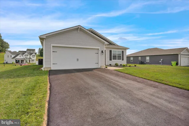a view of a house with a yard and garage