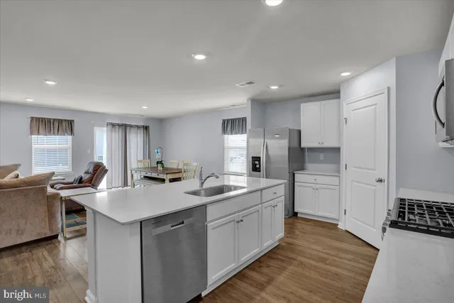 a kitchen with a sink appliances and cabinets