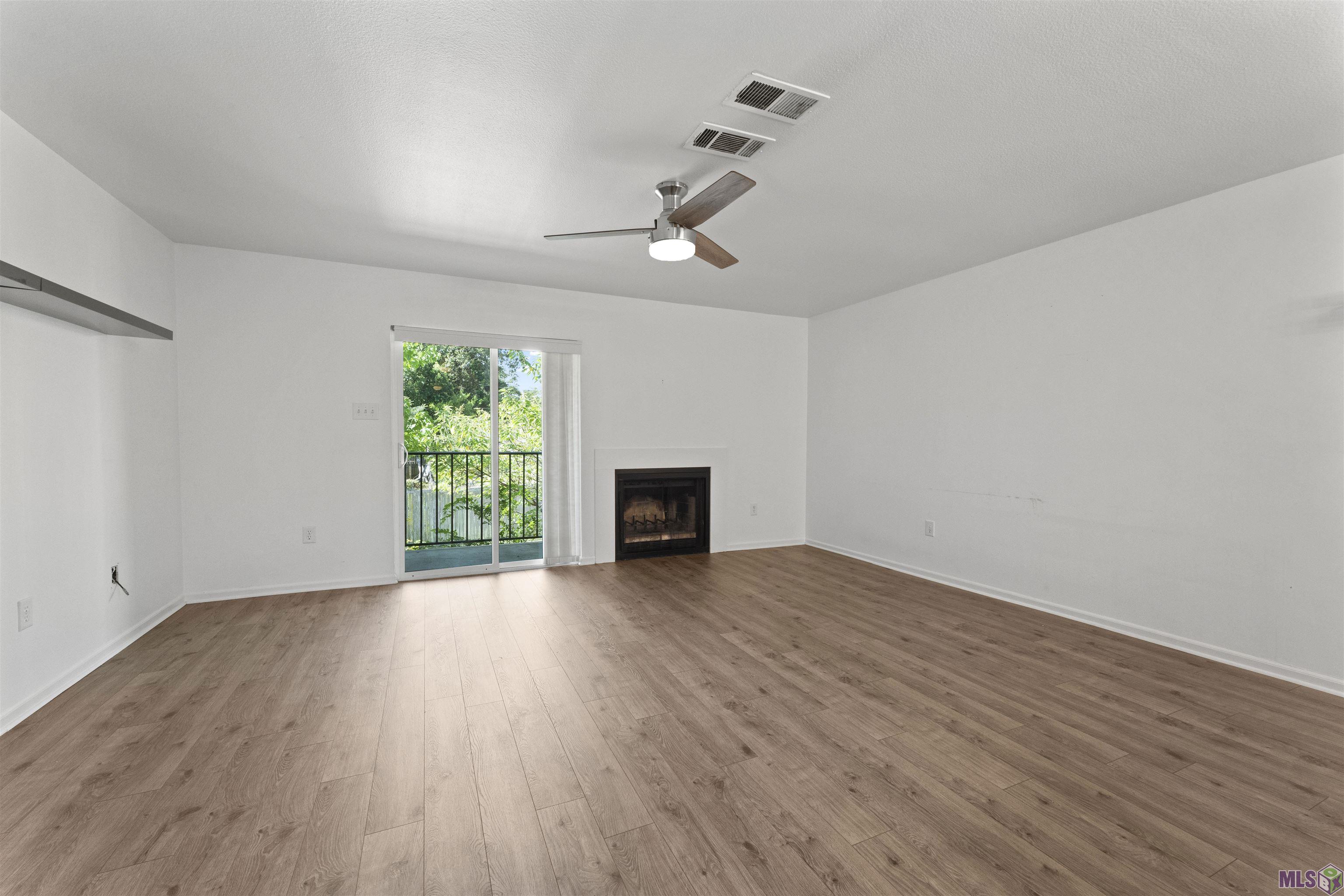 3330 Willard Street, Unit 804 Baton Rouge, LA 70802 - Photo 6 of 25 Living area with fireplace and balcony