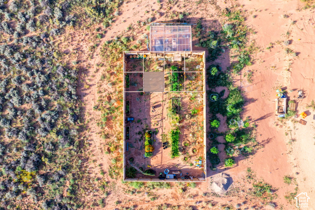 215 South Copper Road East Kanab, UT 84741 - Photo 8 of 41 Enclosed garden with planted beds and an adjacent greenhouse structure