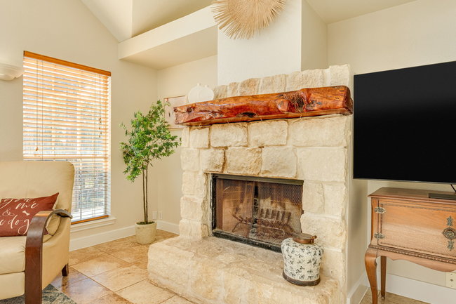 17909 Westward Look Dripping Springs, TX 78620 - Photo 11 of 40 a bedroom with a bed and a fireplace