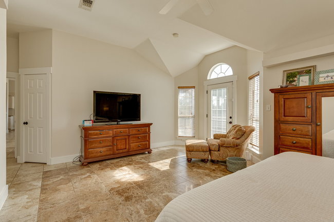 17909 Westward Look Dripping Springs, TX 78620 - Photo 19 of 40 a bedroom with furniture and a flat screen tv