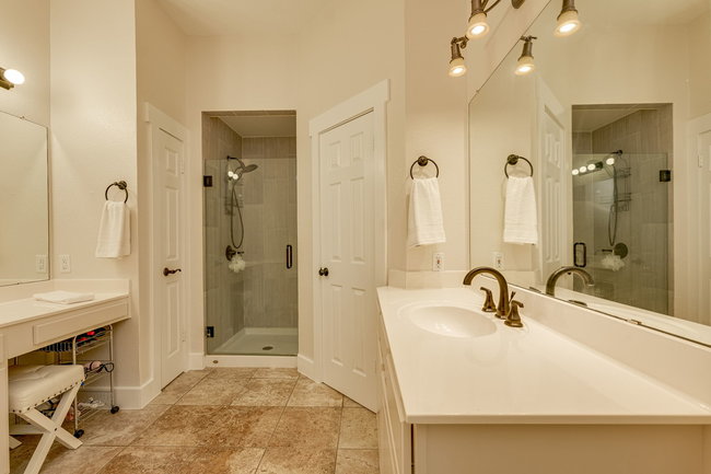 17909 Westward Look Dripping Springs, TX 78620 - Photo 21 of 40 a bathroom with a sink a tub and a mirror