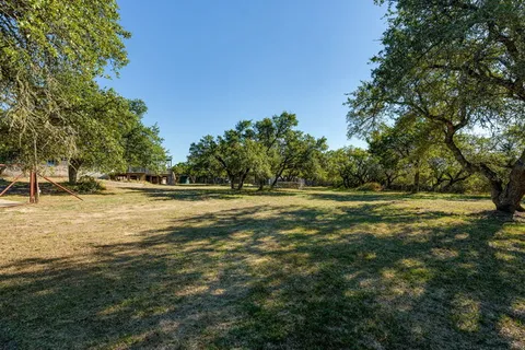 a view of outdoor space with deck and trees