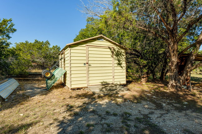 17909 Westward Look Dripping Springs, TX 78620 - Photo 37 of 40 a view of a house with a yard and garage