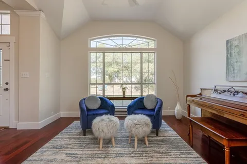 a view of hall way with furniture and a window