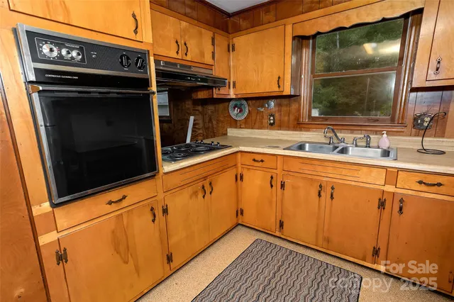 a kitchen with a refrigerator and a sink
