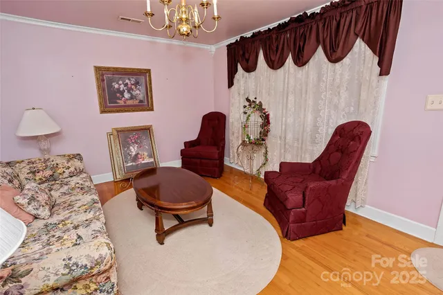 a living room with furniture and a painting on the wall