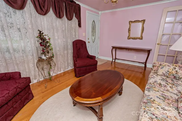 a living room with furniture and a chandelier