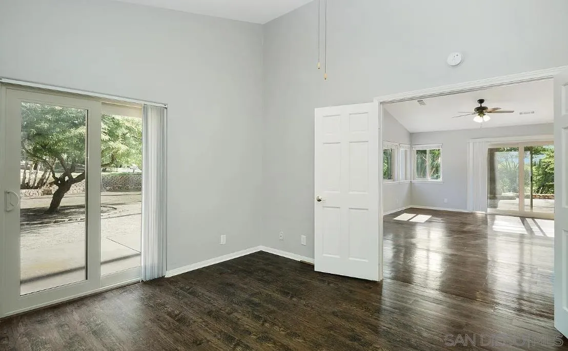 14525 Millards Ranch Lane Poway, CA 92064 - Photo 19 of 29 a view of an empty room with wooden floor and a window