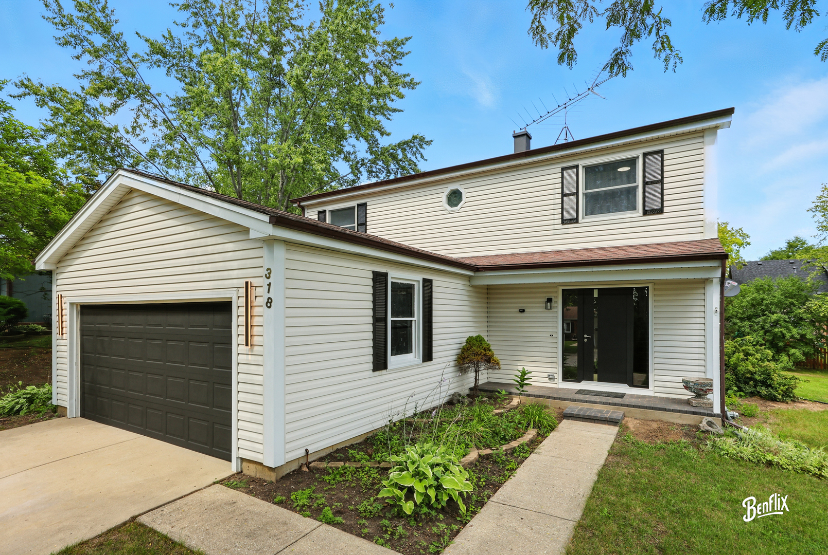 318 Exmoor Drive Streamwood, IL 60107 - Photo 1 of 26 a front view of a house with a garden