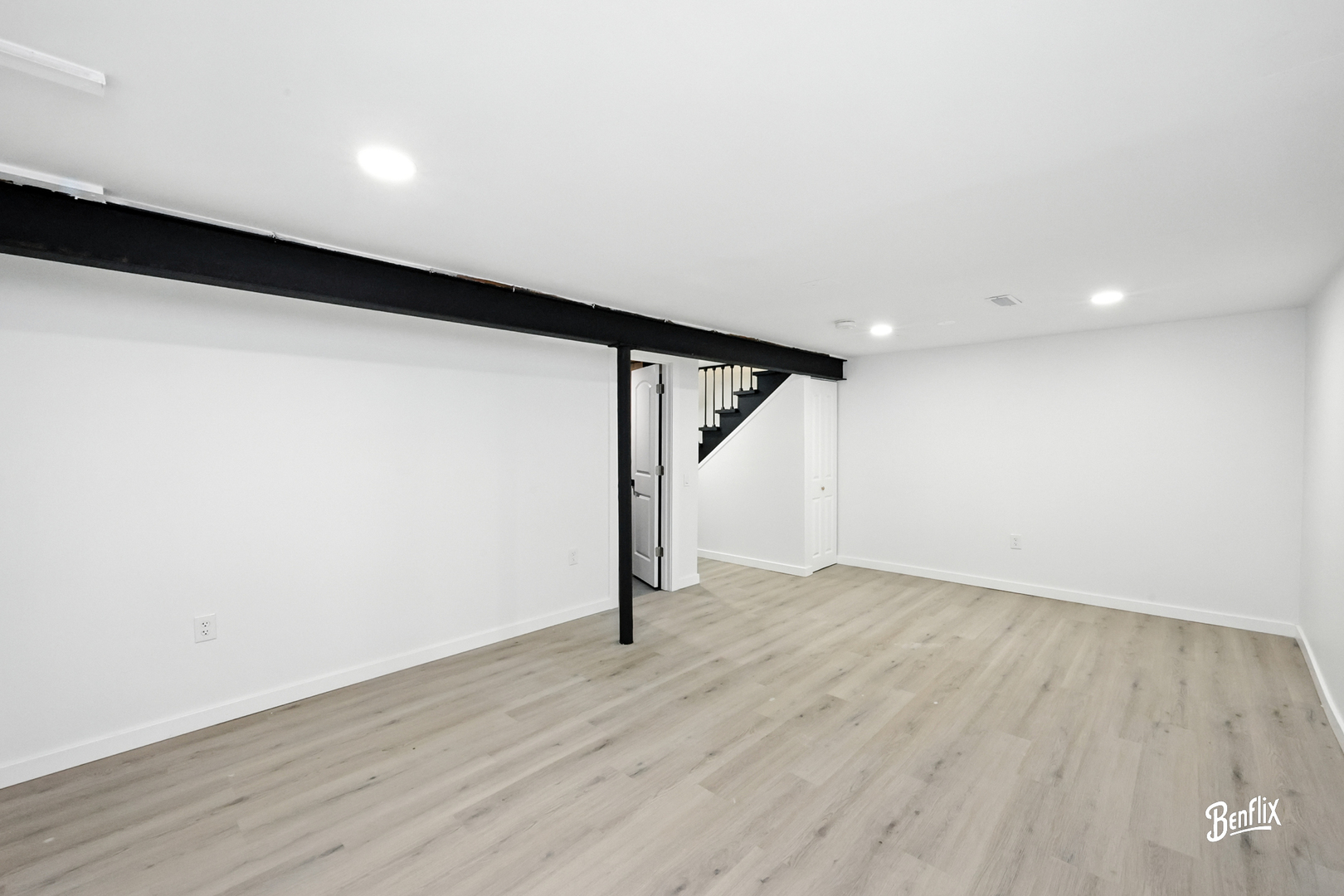 318 Exmoor Drive Streamwood, IL 60107 - Photo 21 of 26 a view of an empty room with wooden floor and stairs