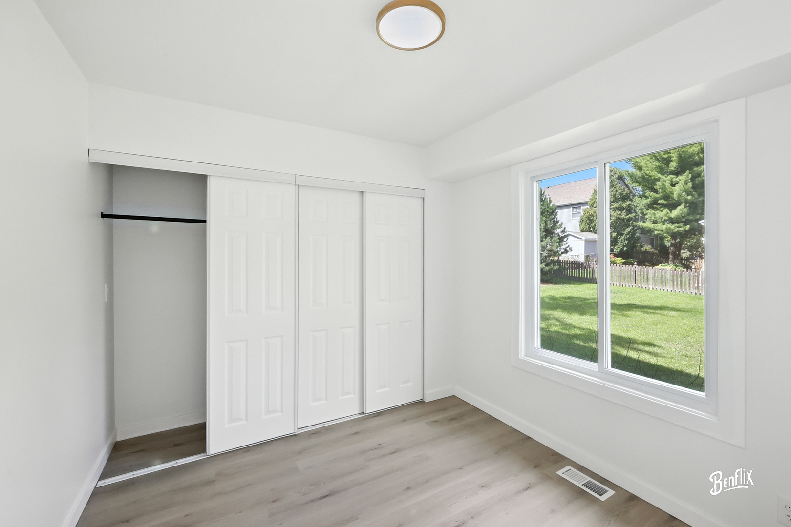 318 Exmoor Drive Streamwood, IL 60107 - Photo 4 of 26 a view of an empty room with wooden floor and a window