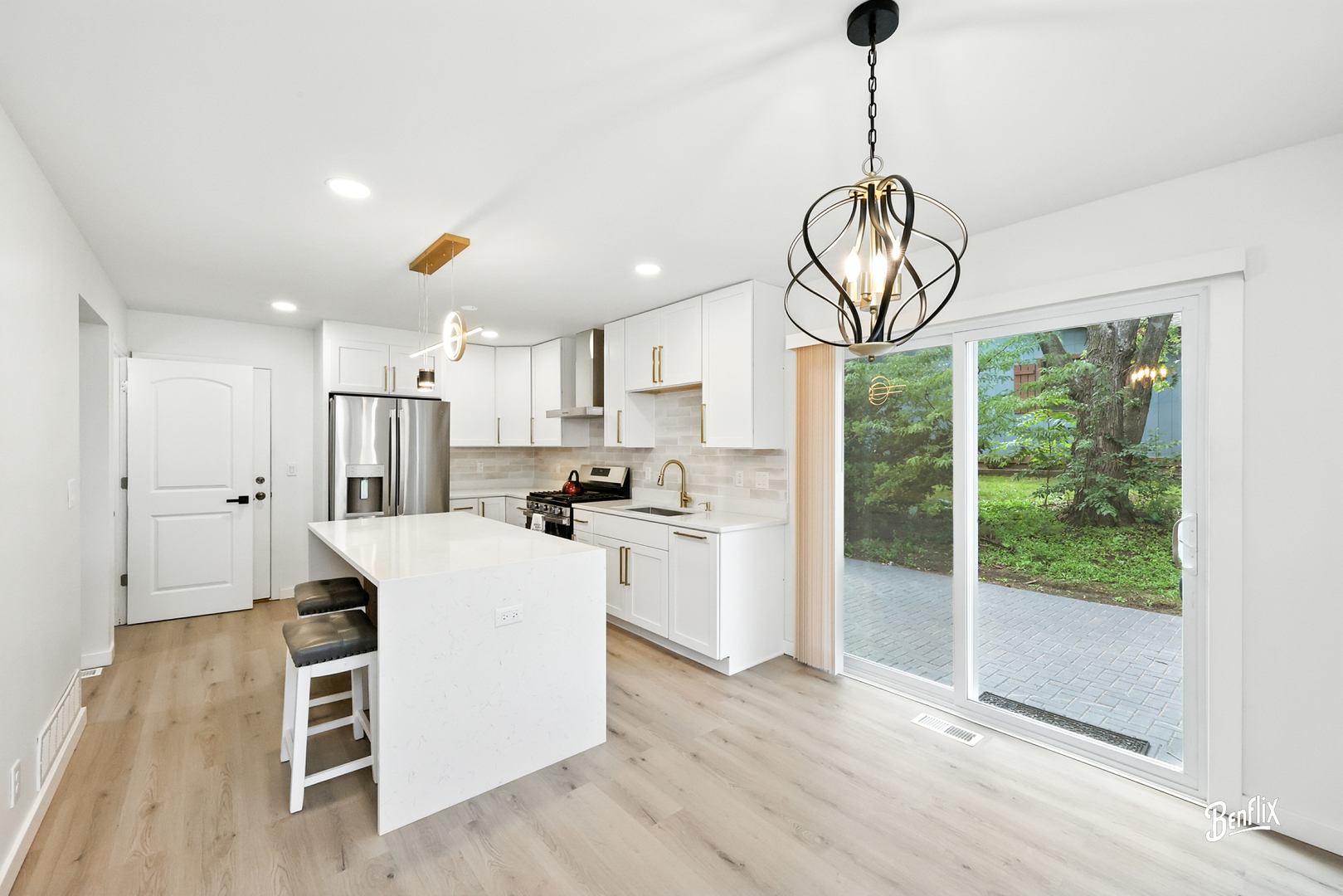 318 Exmoor Drive Streamwood, IL 60107 - Photo 6 of 26 a kitchen with stainless steel appliances kitchen island granite countertop a stove a refrigerator a sink a island and white cabinets with wooden floor