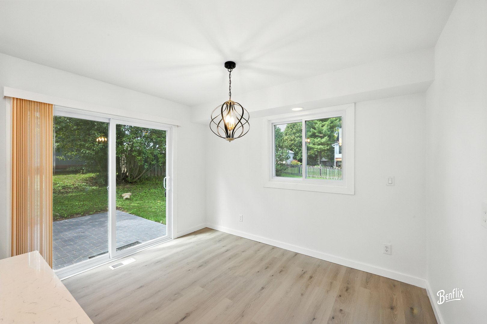 318 Exmoor Drive Streamwood, IL 60107 - Photo 9 of 26 a view of an empty room with wooden floor and windows