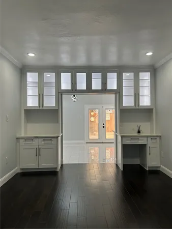 a kitchen with a hard wood floor and a window