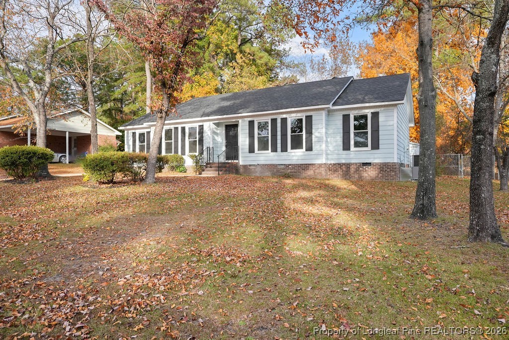 a front view of a house with a yard covered with snow