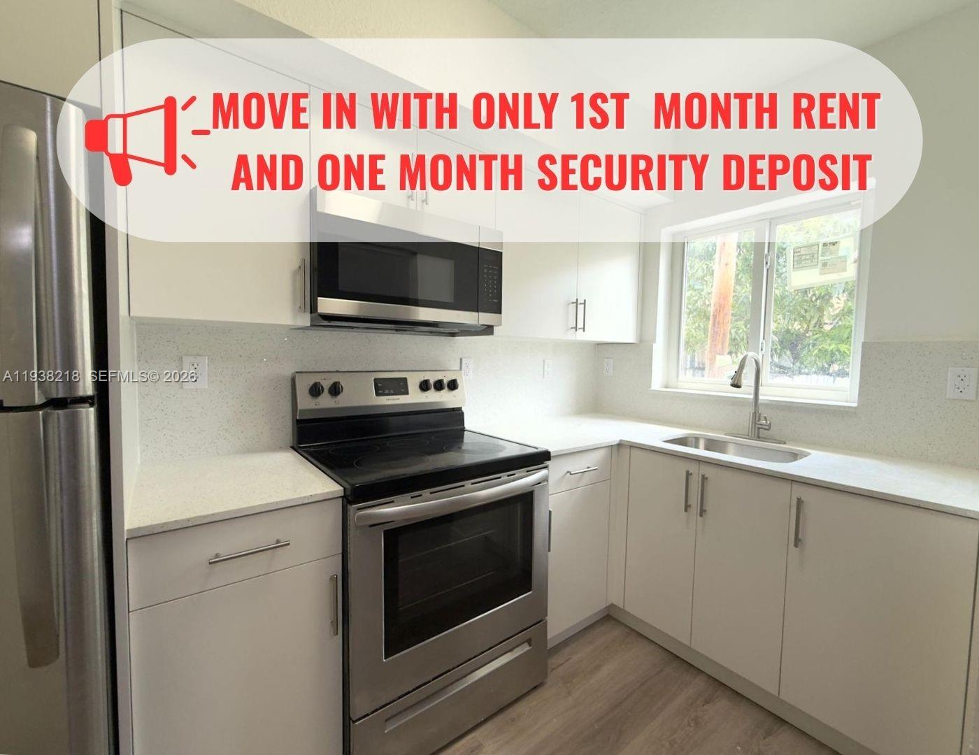 a large kitchen with a red stove and a microwave