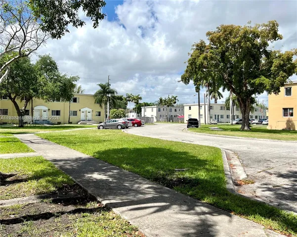 a view of a park with large trees