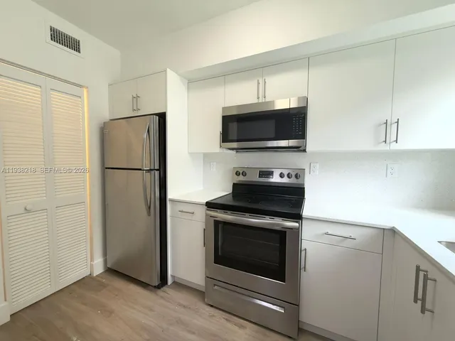 a kitchen with a refrigerator stove and microwave