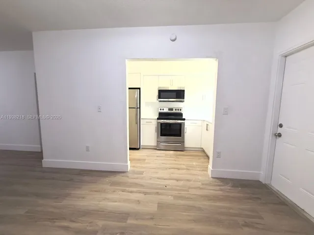 a view of a kitchen with a sink and an oven