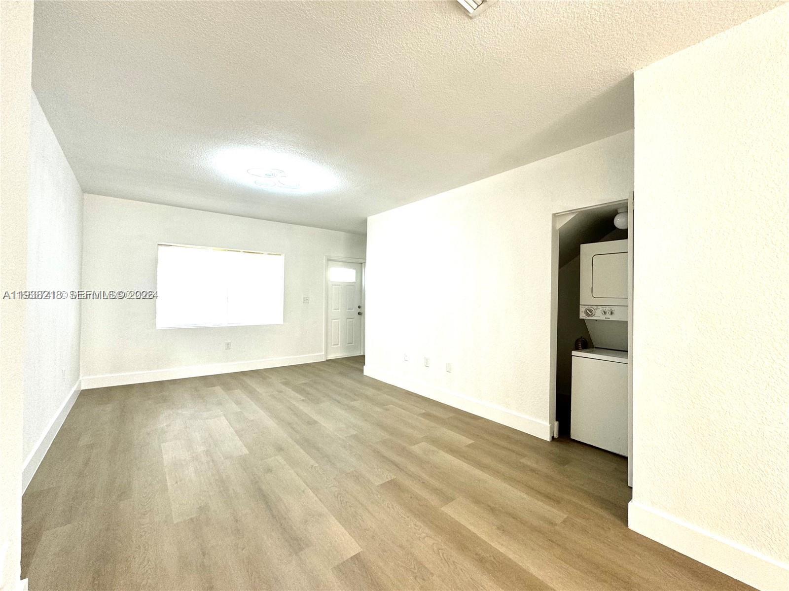 424 Northwest 84th Street, Unit 424 Miami, FL 33150 - Photo 6 of 15 a view of an empty room and wooden floor