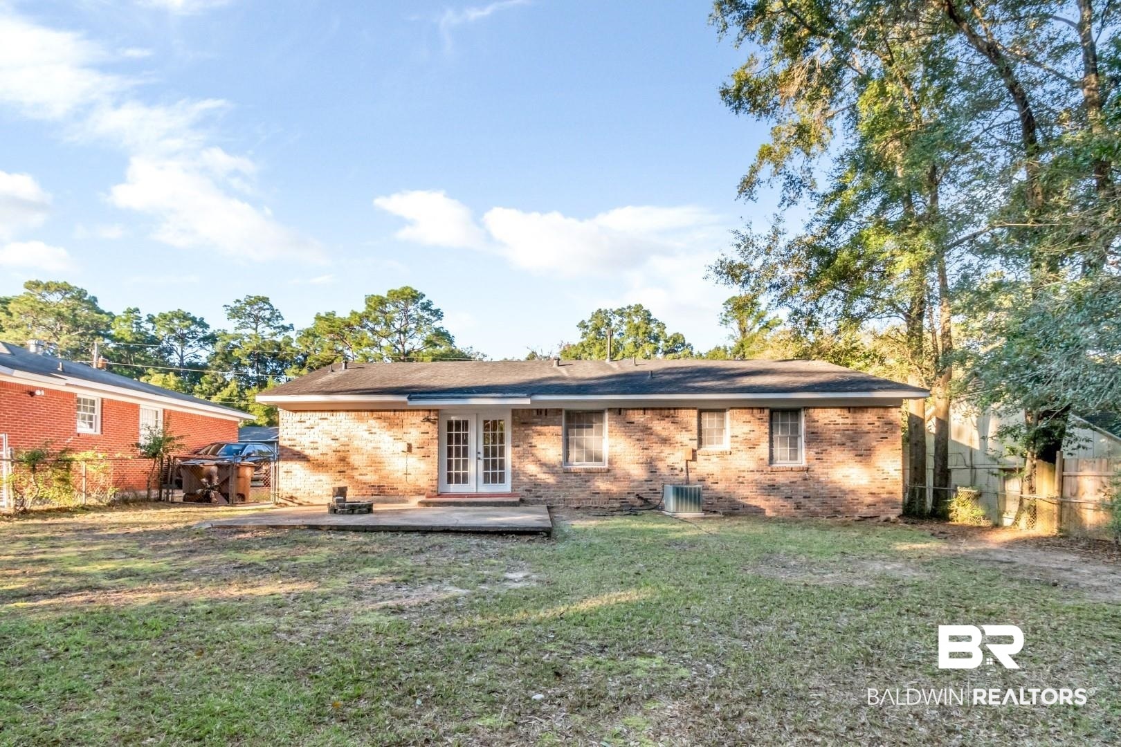 5517 Vanderbilt Drive Mobile, AL 36608 - Photo 29 of 33 Back of property with french doors, a patio area, and a lawn