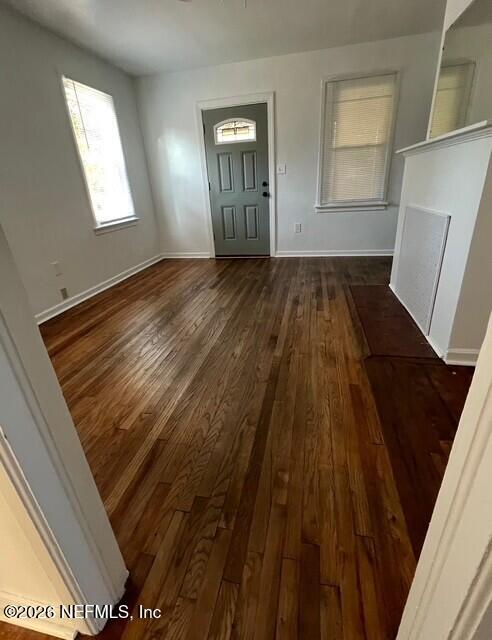 7307 Clinton Street Jacksonville, FL 32208 - Photo 7 of 17 a view of an empty room with wooden floor and a window