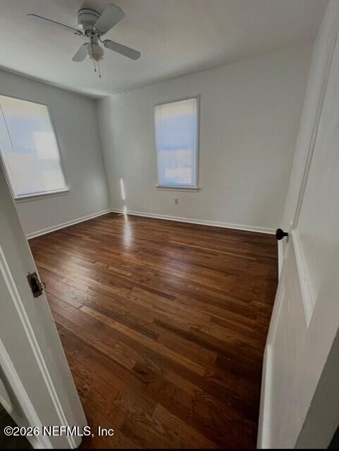 7307 Clinton Street Jacksonville, FL 32208 - Photo 8 of 17 an empty room with wooden floor fan and windows