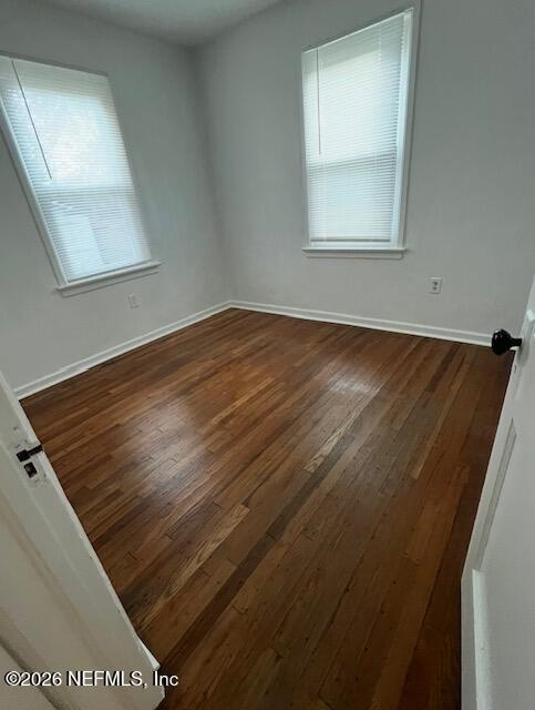 7307 Clinton Street Jacksonville, FL 32208 - Photo 9 of 17 an empty room with wooden floor and windows