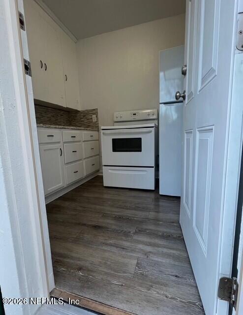 7307 Clinton Street Jacksonville, FL 32208 - Photo 10 of 17 a kitchen with stainless steel appliances wooden floor sink and stove
