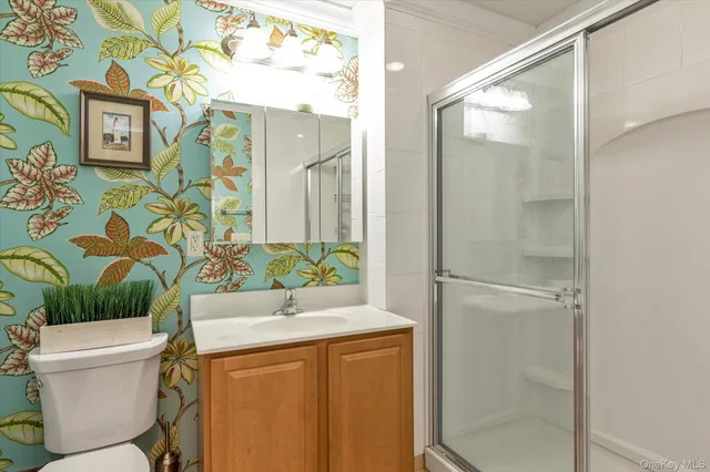 a bedroom with a large bed and a painting on the wall