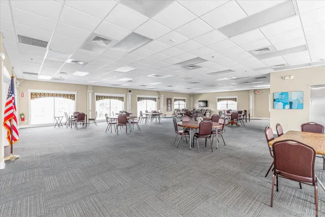 a room with gym equipment and lots of windows