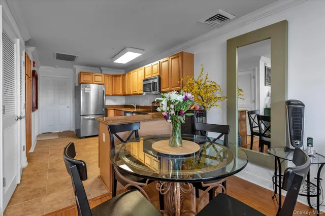 a view of a dining room with furniture and a potted plant