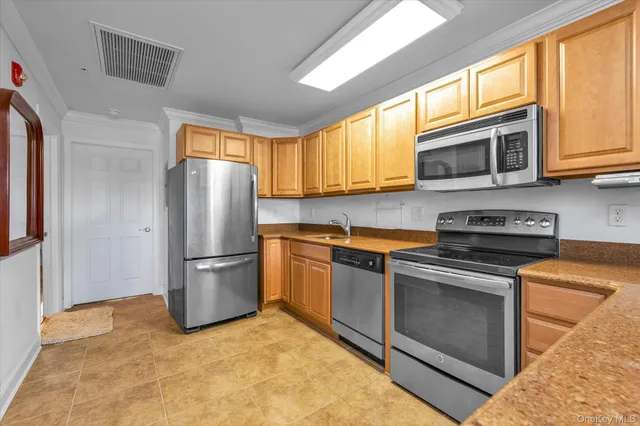a kitchen with a refrigerator sink and microwave