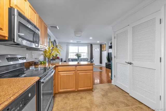 a kitchen with a sink cabinets and window