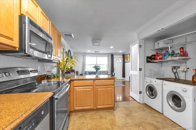 a kitchen with stainless steel appliances granite countertop a refrigerator a stove and a sink with cabinets